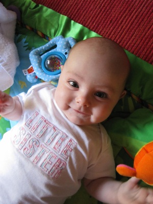 Evie Lattimore, 4 months old & smiling on play mat