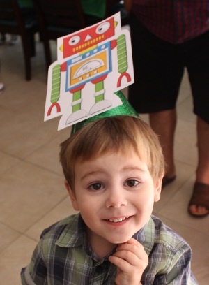 Hugo Lattimore - 4th Birthday Wearing A Robot Party Hat