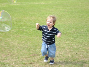 Hugo chasing bubbles on his second birthday