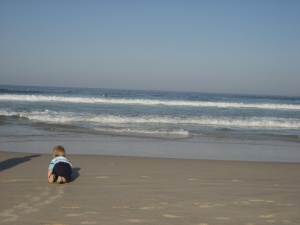 Hugo Lattimore crawling toward the surf at Kingscliff beach