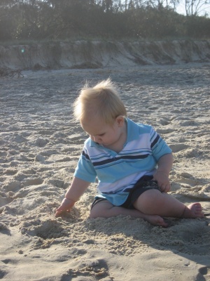 Hugo Lattimore enjoying playing in the soft sand at Kingscliff beach