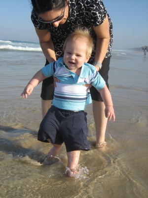 Hugo Lattimore splashing his feet in the water at Kingscliff beach